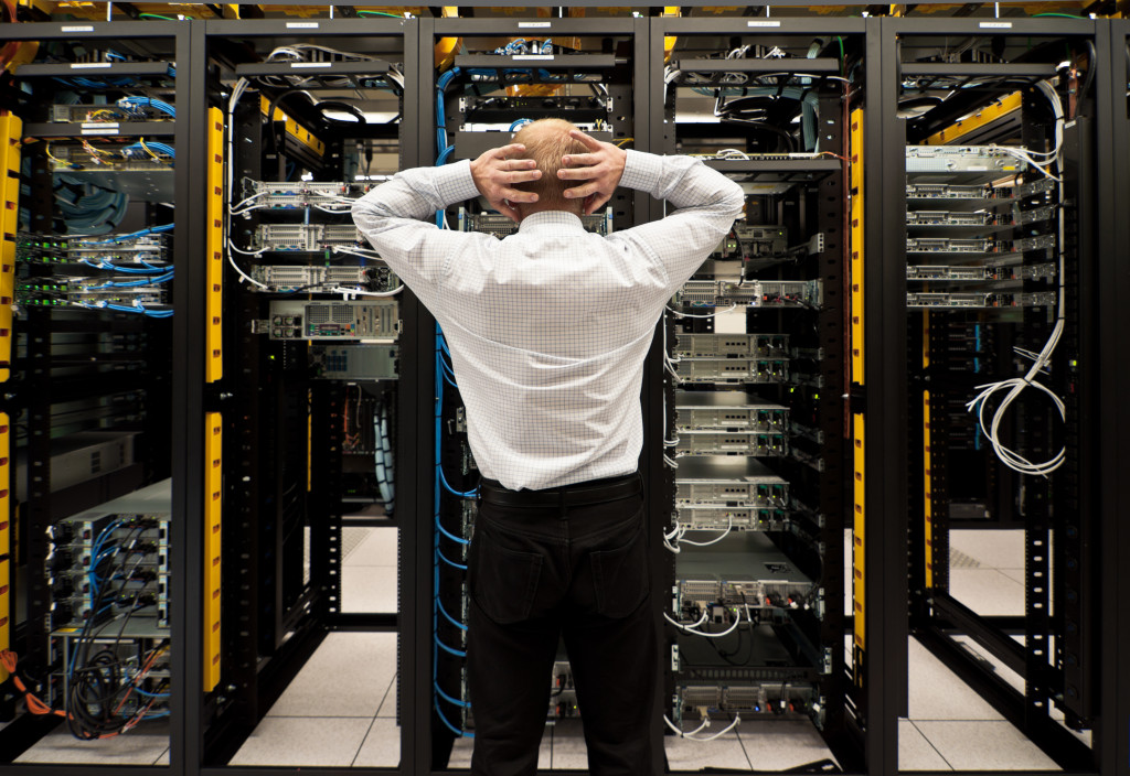 Man looking astonished in a network data center.